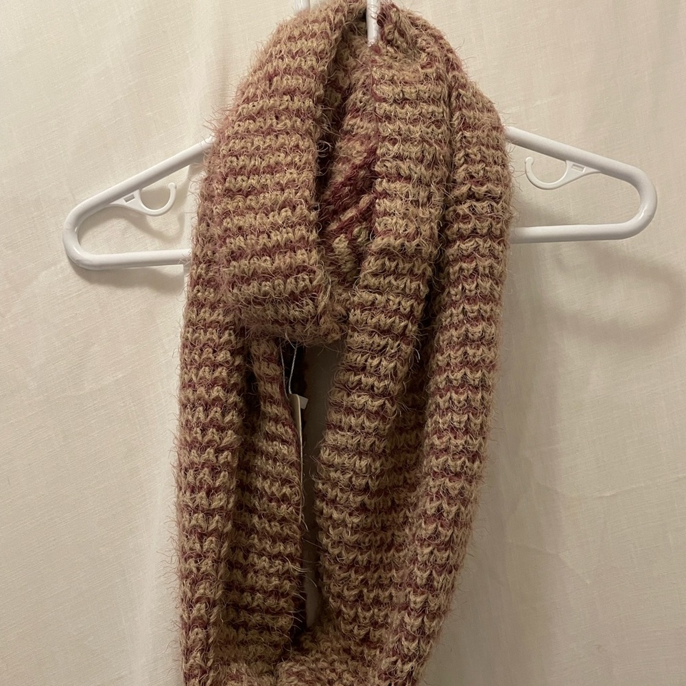 Simply Noelle infinity knit scarf. 
Acrylic and nylon based. 
Tan and purple